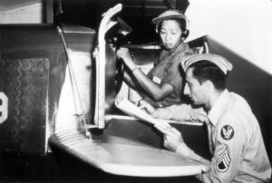 Hazel Ying Lee reviews her performance after a session in a Link trainer, 1944